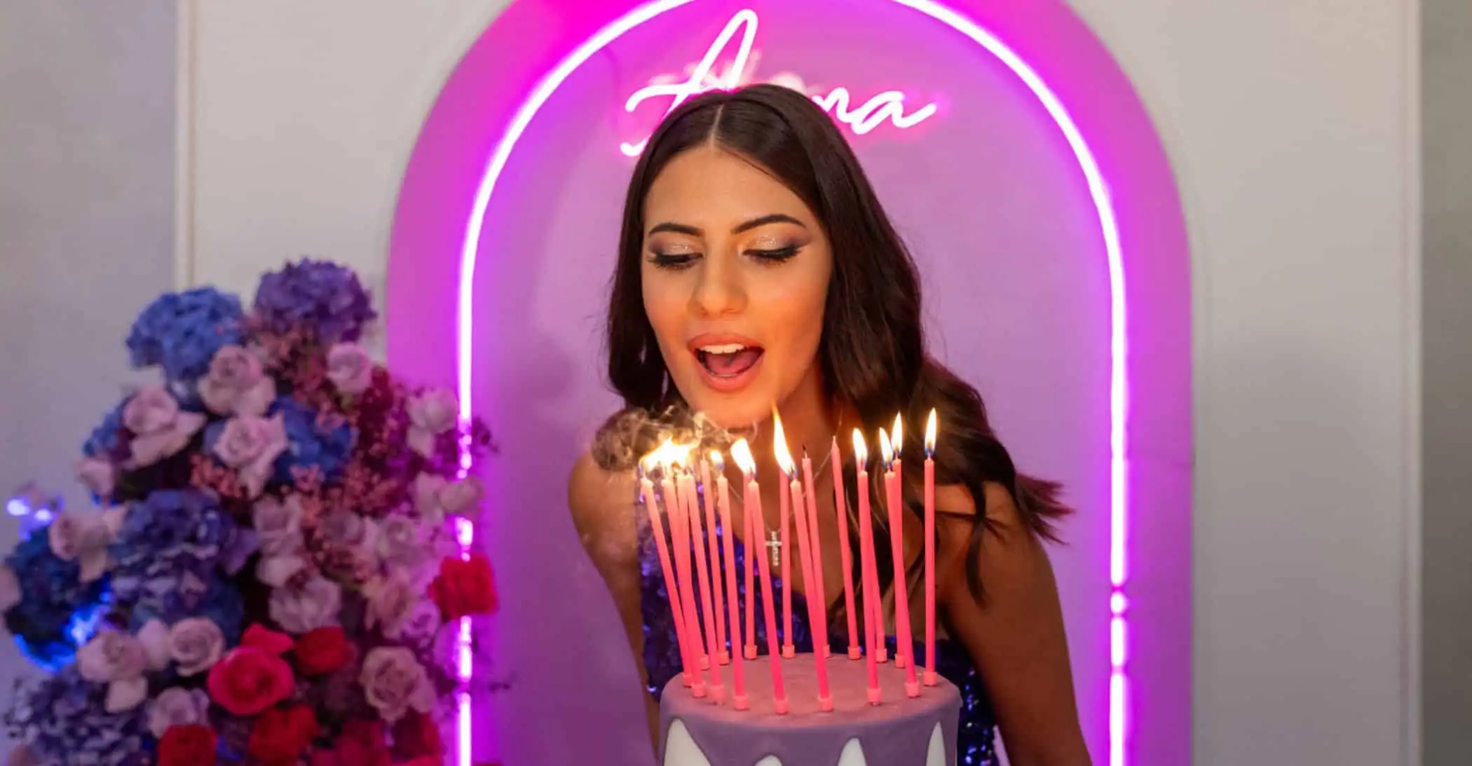 Candle and woman celebrating birthday with cake at ChiaraB Events Wedding Planner, wedding and special event planning service.
