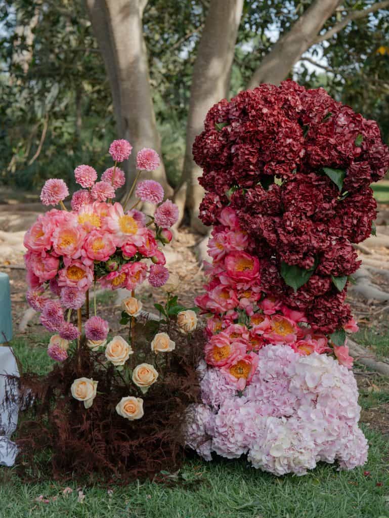 Decorative wedding flowers with arrangements of peonies, roses, and hydrangeas in a garden, perfect for wedding planners and floral setups.
